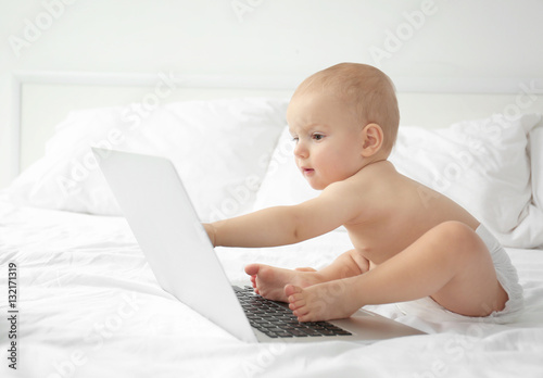Cute baby boy with laptop o...