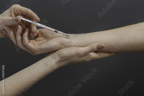 Close up of doctors hands making an injection