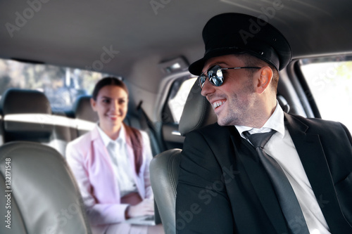 Businesswoman riding a car with chauffeur © Africa Studio