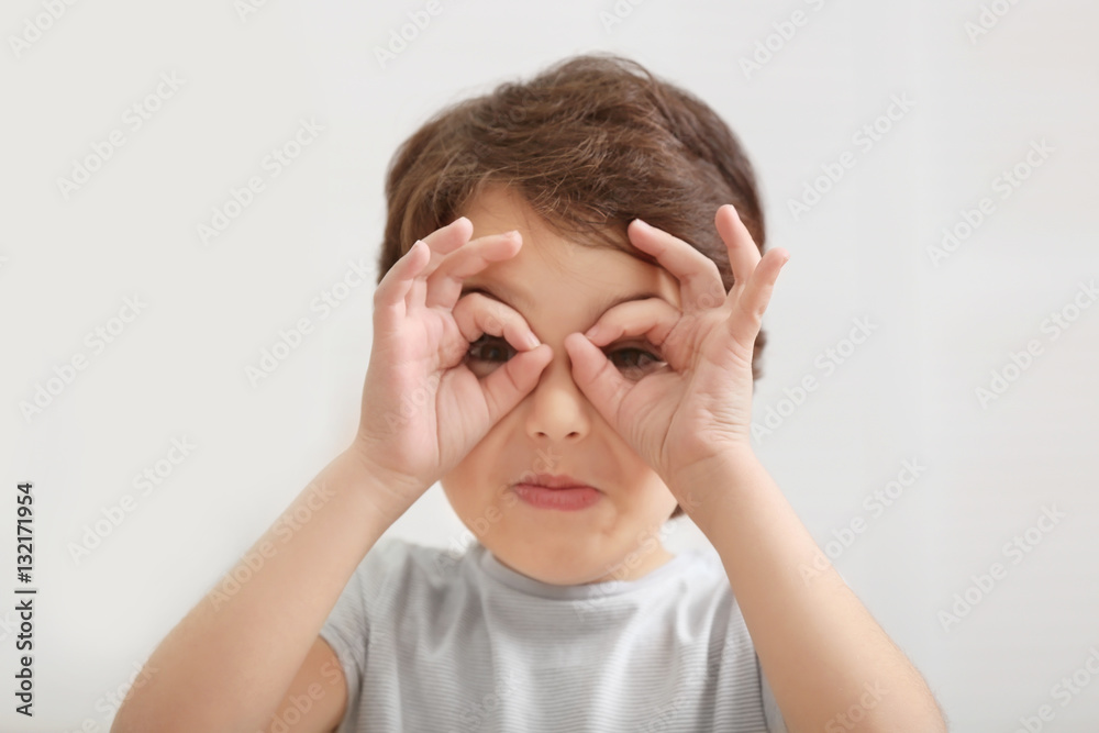Cute emotional little boy on light blurred background Cute emotional little boy on light blurred background