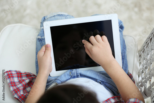 Little boy sitting with tablet, close up