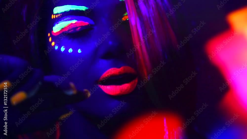 Fashion model woman in neon light, beautiful model girl with fluorescent make-up, Art design of female disco dancer dancing in UV, colorful make up. Night club, Party. Full HD 1080p video footage