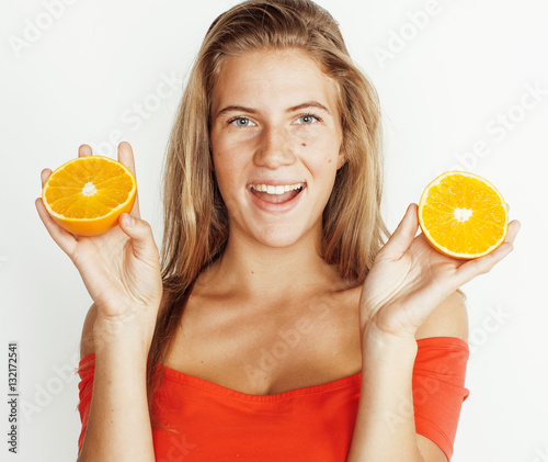 young pretty blond woman with half oranges close up isolated on white bright teenage smiling