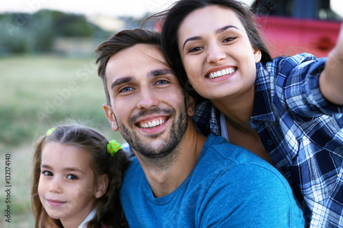 Parents with kid taking photo