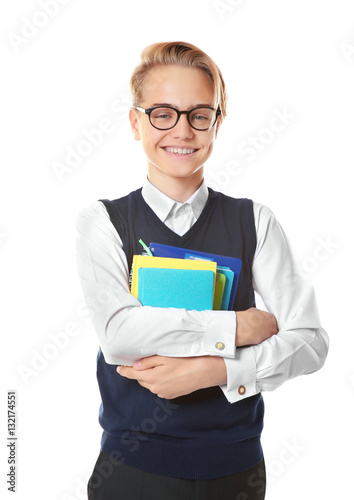 Teenage boy holding books o...