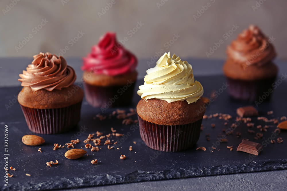 Tasty chocolate cupcakes on dark slate plate