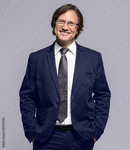 Confident man in suit on gr...