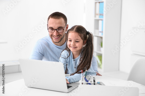 Daughter helping father wor...