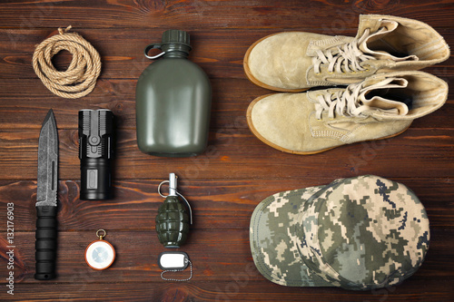 Military equipment on wooden background