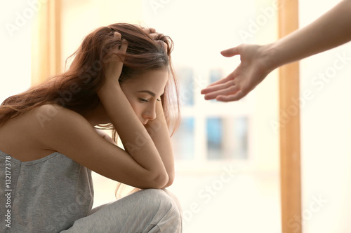 Someone giving hand to depressed woman at home photo