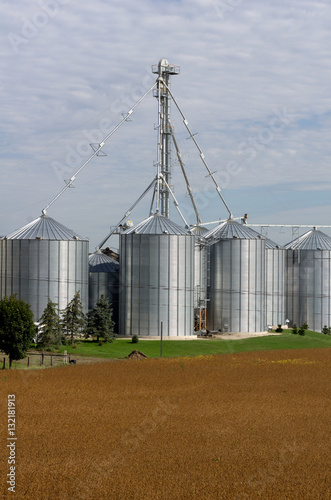 A metal grain facility with silos