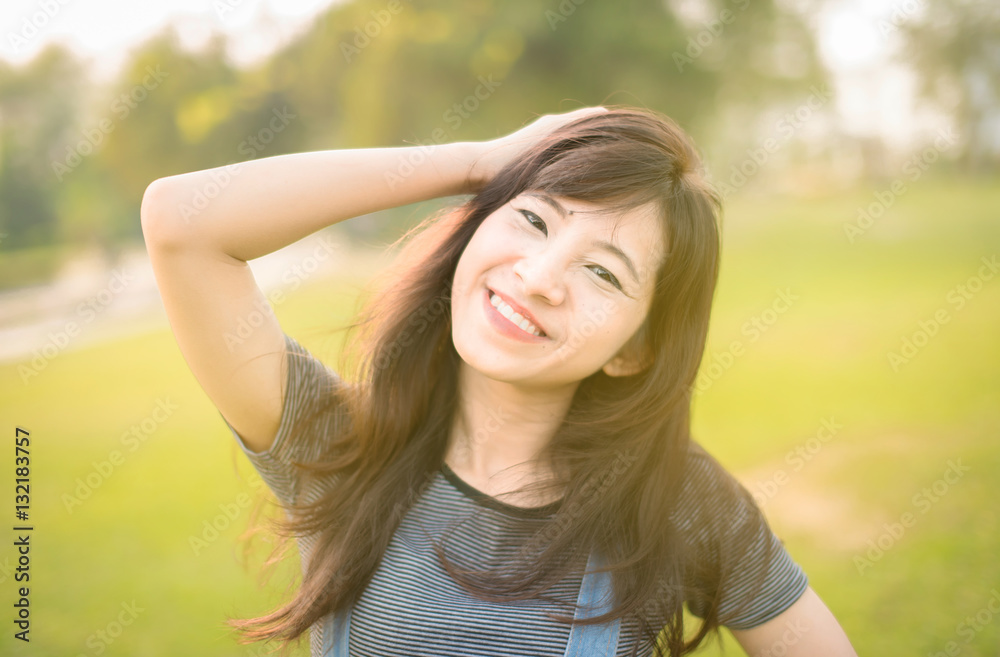 Woman relaxing in park enjoying her freedom wear short dress,Woman smiling happy freedom with sunlight 