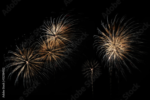 Festive fireworks colorful display isolated in bursting shapes on black background. Happy new year 2017. Beautiful light for celebration. Show explosion wallpaper during eve. Abstract blur dark scene.