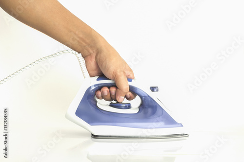 man's hand holding iron on white background