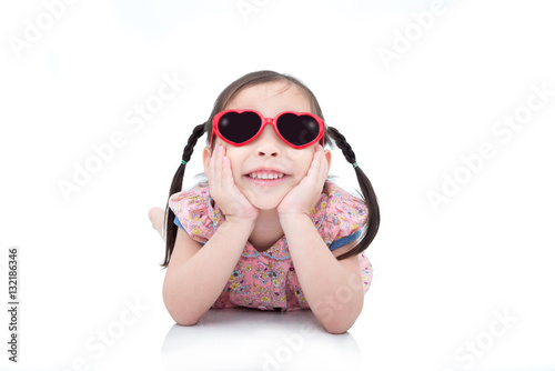 Little asian girl wearing sunglasses and hat over white backgrou