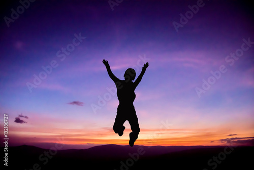 Silhouette of Child jumping up at Sunset