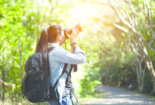 Professional woman photographer taking outdoor portraits with prime lens