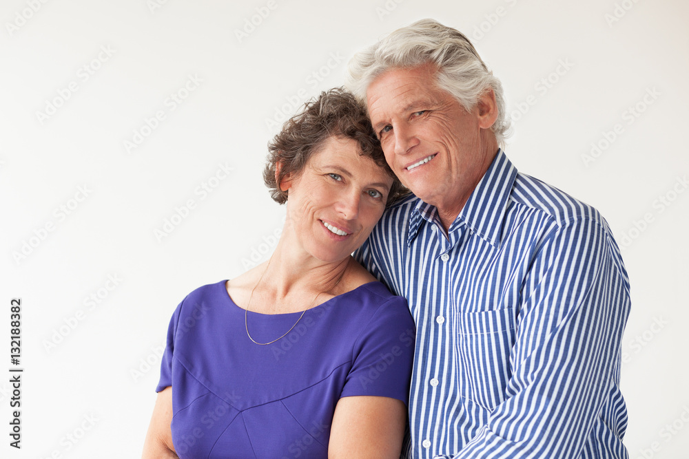 Happy Elderly Couple Hugging and Smiling Happy Elderly Couple Hugging and Smiling