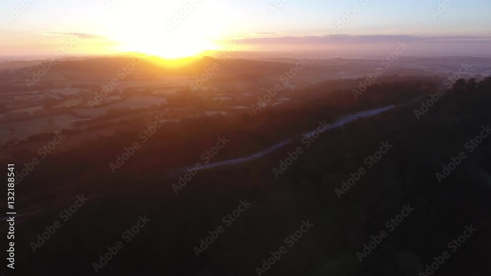 Slow aerial shot of a frozen walking route in the hills at sunrise. Slow aerial shot of a frozen walking route in the hills at sunrise.