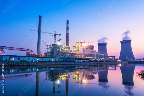 modern waterfront power plant at sunset