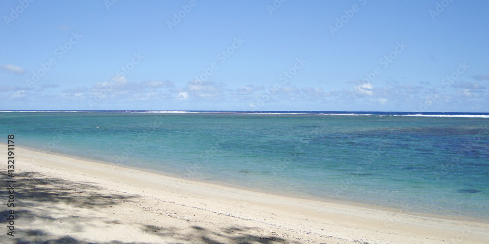 A sunny beach with fine white sand and a warm sea
