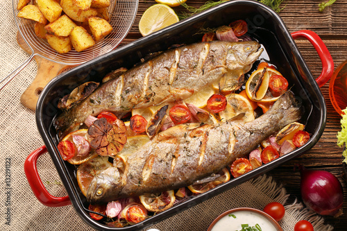 Canvas Print Baked fish with vegetables and potatoes in pan