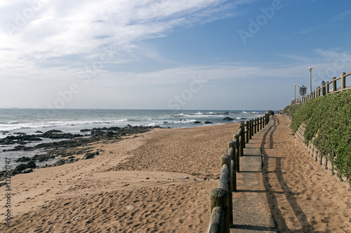 Retaining Wall and Wooden Barrier on Empty Beach