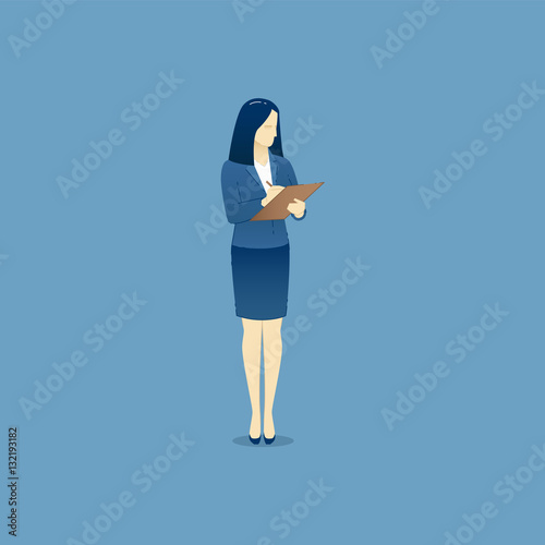 Business woman stands and writes on clipboard