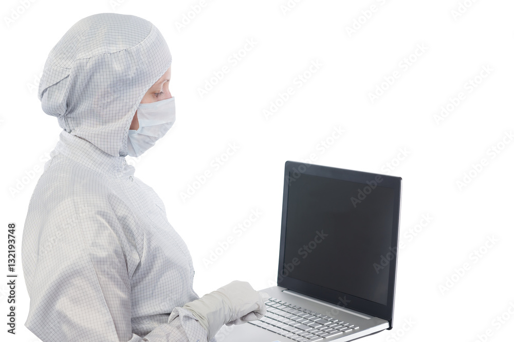 scientist in a suit and mask works with the computer on a white background scientist in a suit and mask works with the computer on a white background