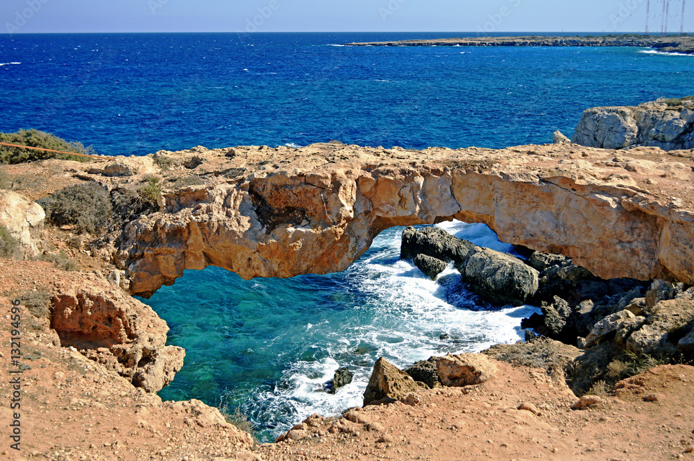 Natural stone bridge over the sea on the coast of Cyprus.