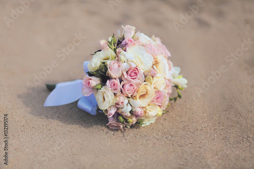 Beautiful vintage wedding bouquet flowers roses on sand beach