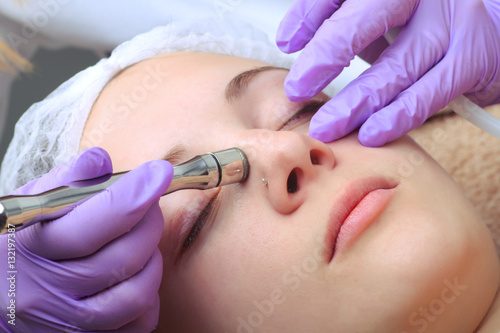 Diamond microdermabrasion, peeling cosmetic. woman during a micr photo