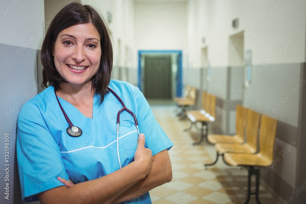 Portrait of female surgeon standing in corridor Portrait of female surgeon standing in corridor