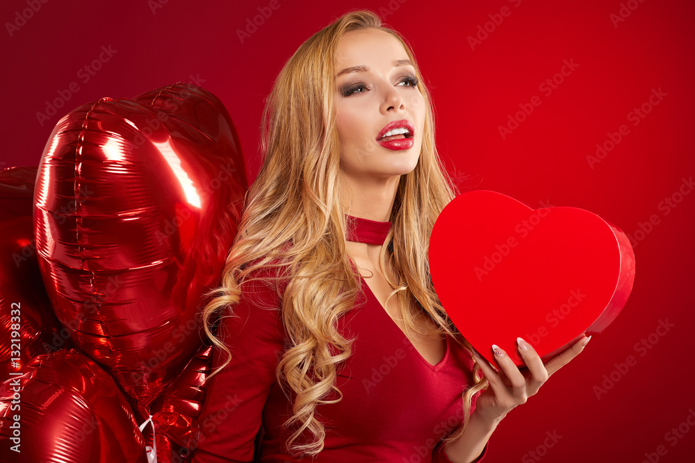 woman with red heart balloon on red valentines day background woman with red heart balloon on red valentines day background
