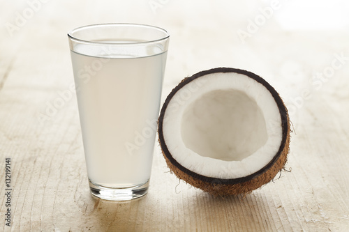 Coconut with a glass of coconut water photo