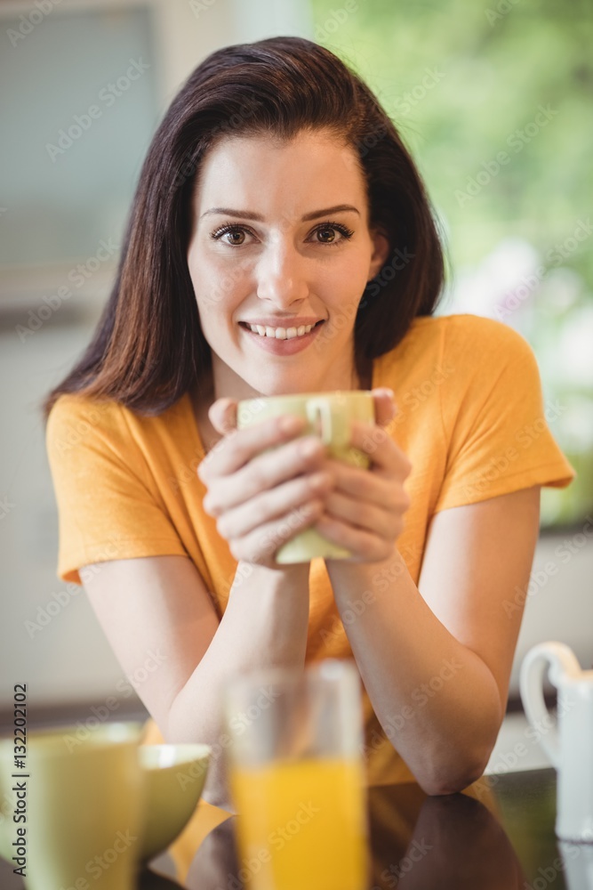 Beautiful woman having coffee in kitchen Beautiful woman having coffee in kitchen