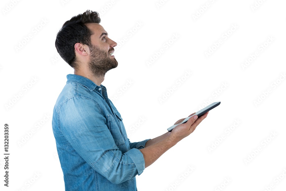 Handsome man looking up while holding a digital tablet Handsome man looking up while holding a digital tablet
