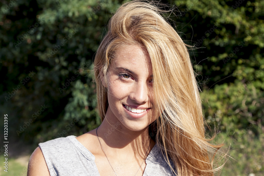 Naklejka premium portrait of smiling beautiful young woman outdoor on vacation