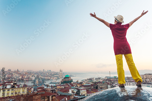 Sunrise View of large eastern City Woman raising Hands