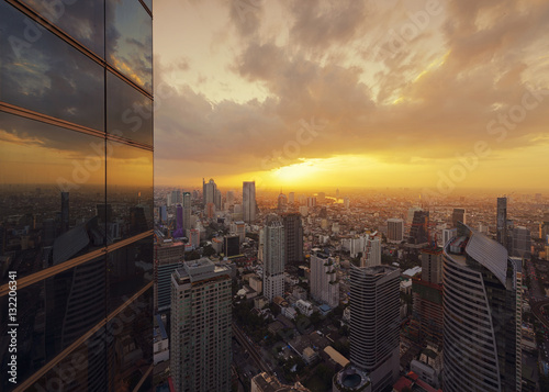 The Reflection of Skyscrapers at Sunset in Bangkok, Thailand photo