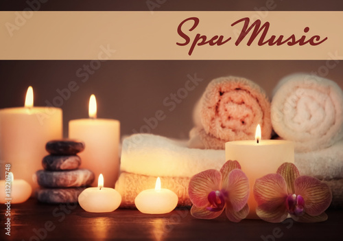 Spa music concept. Candles with flowers on table