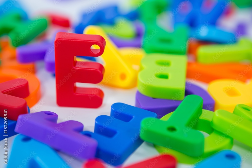 E alphabet standing between toy alphabet E alphabet standing between toy alphabet