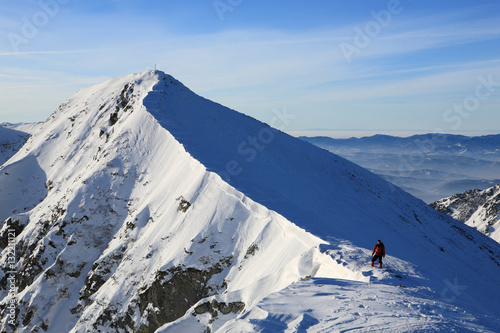 The climber climbs to the top of the mountain in the Carpathians