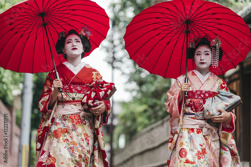 Maiko geishas walking on a ...