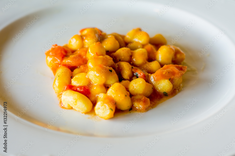 Tomato dumplings on white porcelain plate Tomato dumplings on white porcelain plate