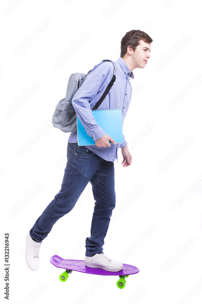 Teenager male student skateboarding over white background Teenager male student skateboarding over white background