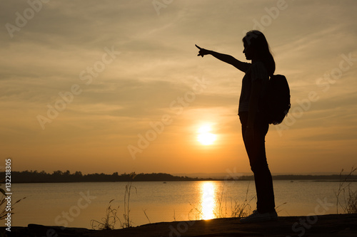 Young woman relaxing in summer sunset sky outdoor