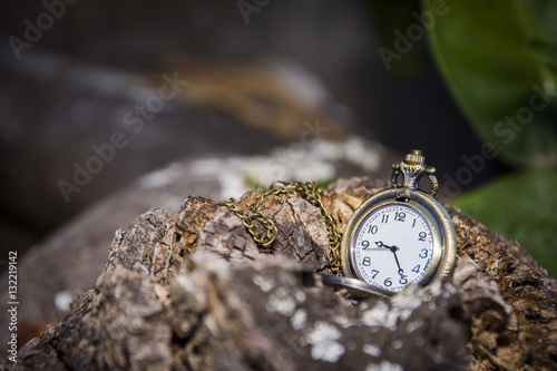 watch locket on the wooden table dark background