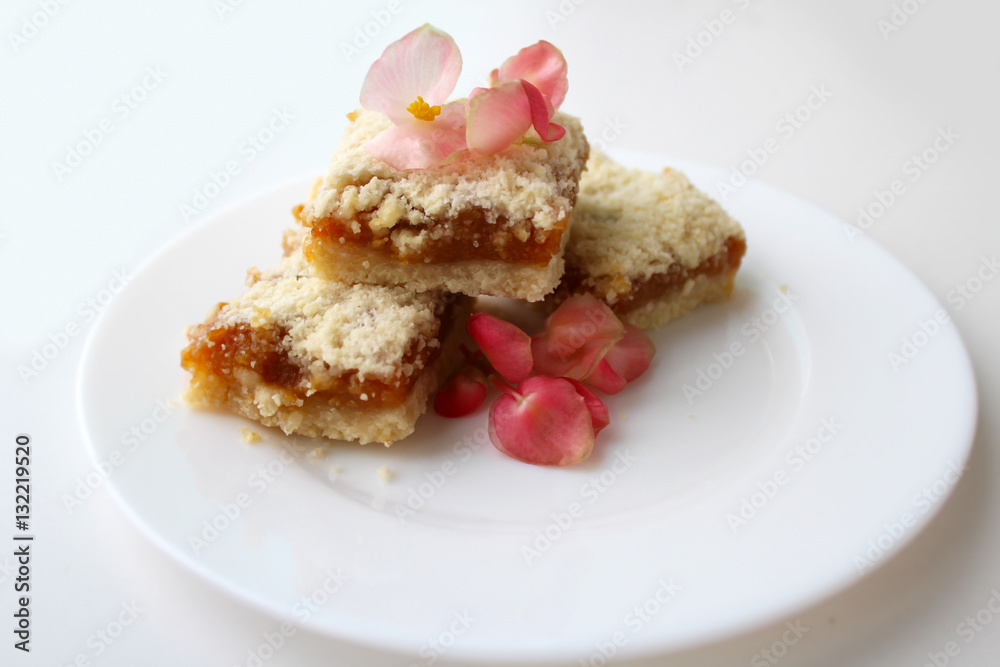 Homemade baking. Appetizing biscuits with pink flowers on a plate Homemade baking. Appetizing biscuits with pink flowers on a plate