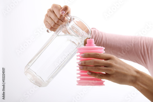 Kobieta nalewa wodę do irygatora 